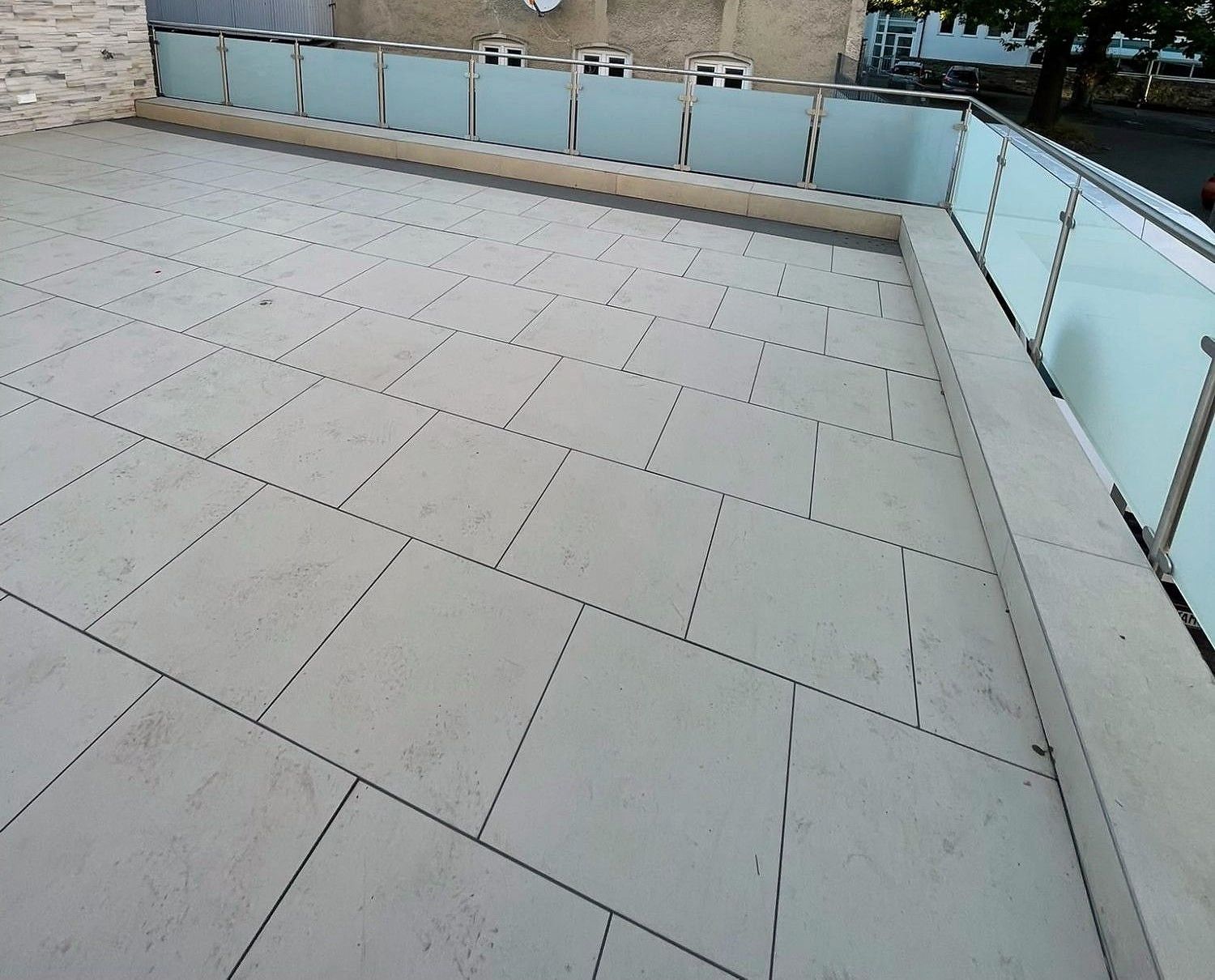 Umlaufendes Glasgeländer mit Edelstahlpfosten und Milchglas auf einer Dachterrasse